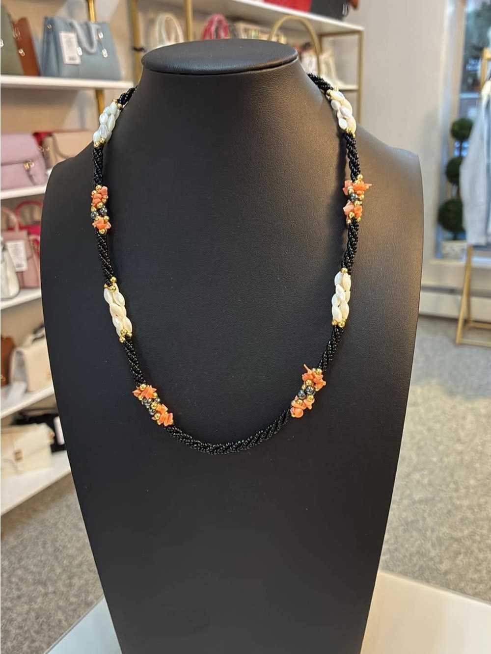 Handcrafted Black Bead Necklace with Orange Accents and Ivory Bead Clusters